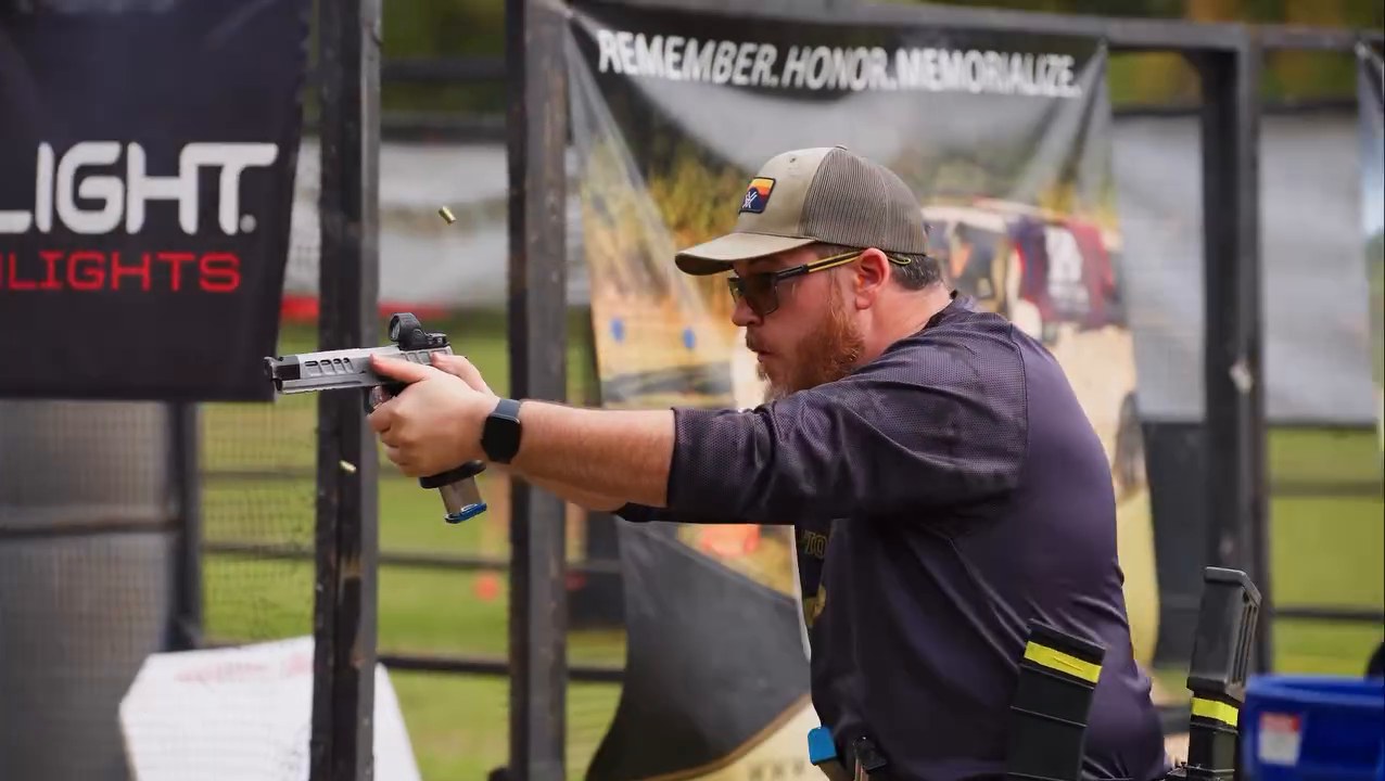 A competitor engages targets with his pistol