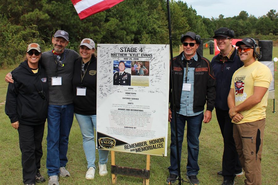 Members of the Evans family gather at the Stage 4 sign for SFC Matthew “Kyle” Evans at the 2025 Memorial 3 Gun